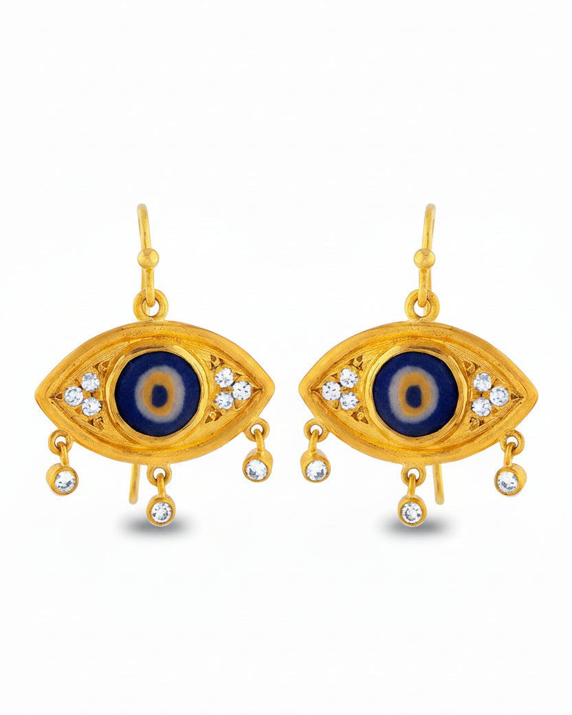 Gold eye-shaped earrings with blue centers on a white background