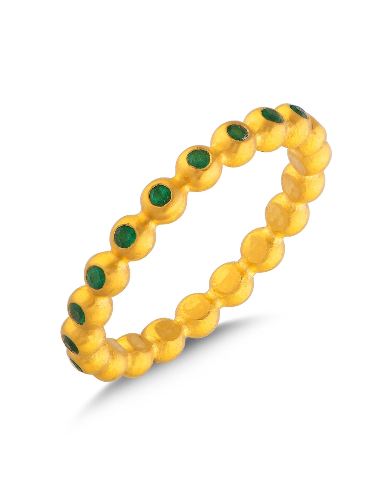 Gold beaded ring with green gemstones on a white background