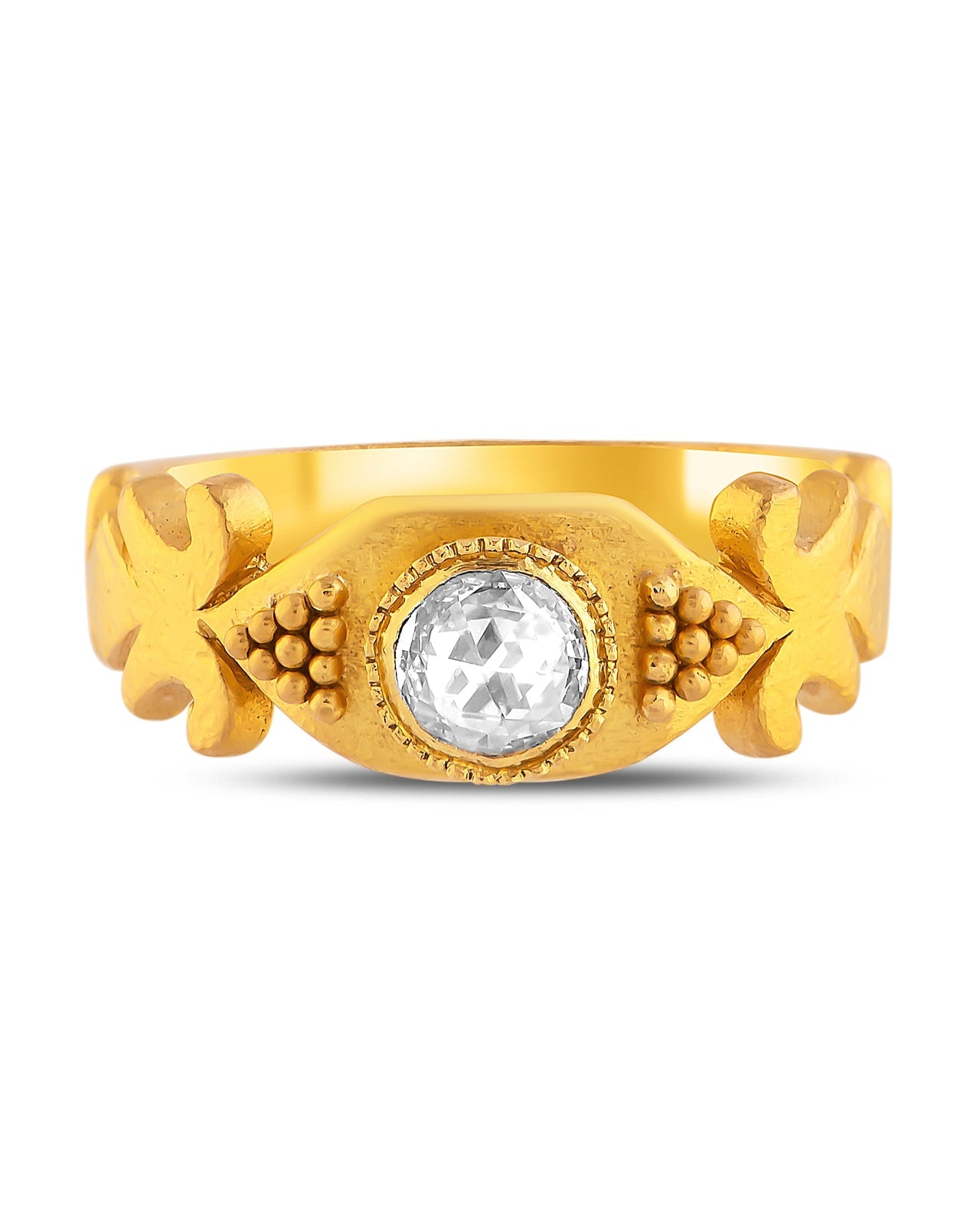 Gold ring with a central gemstone on a white background