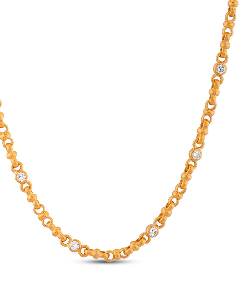 Gold chain necklace with small diamonds on a white background