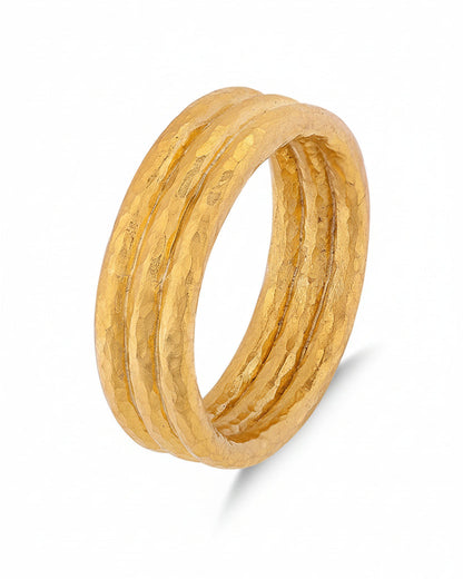 Gold ring with a textured design on a white background