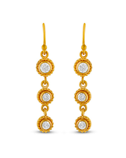 Gold earrings with circular designs and clear stones on a white background