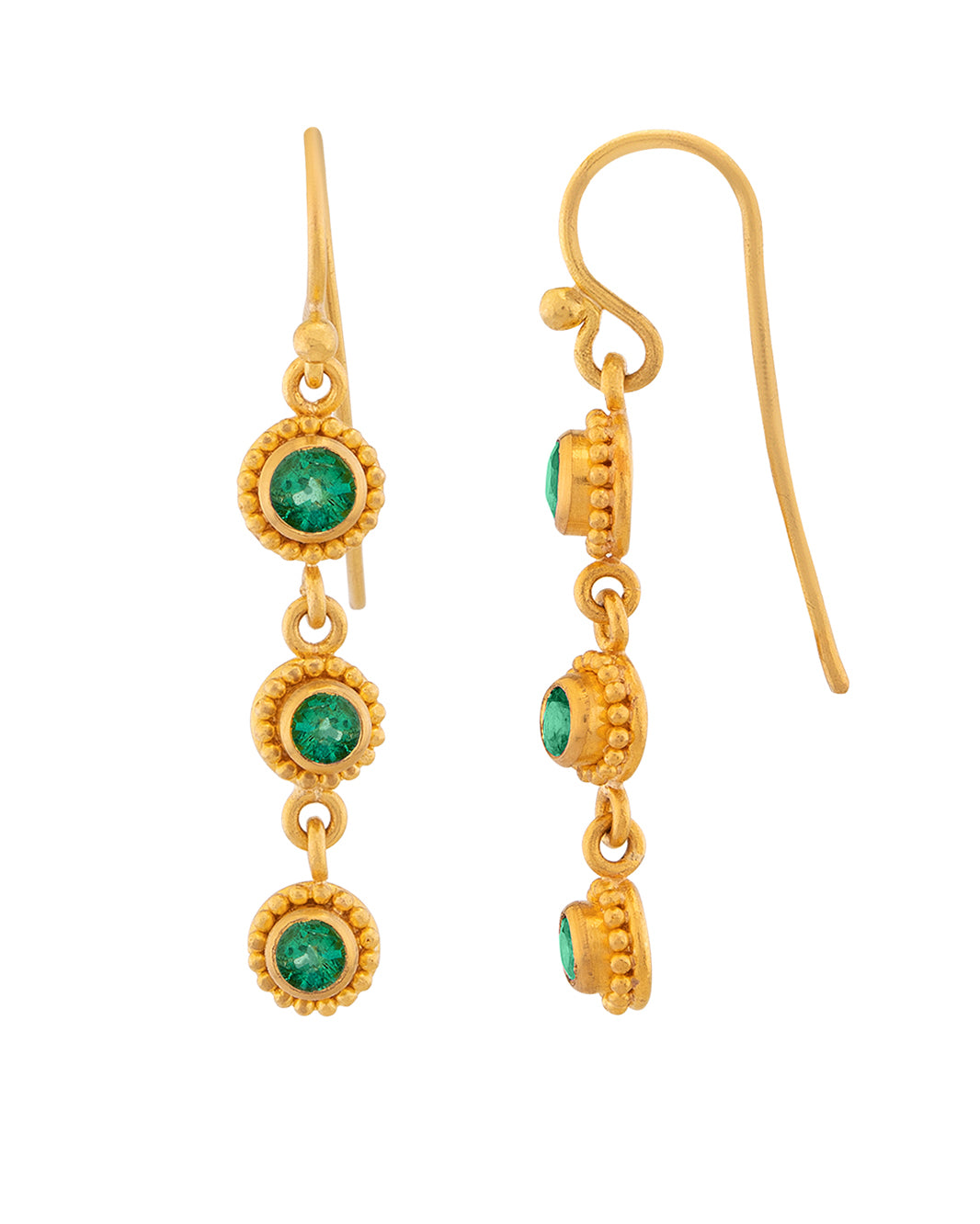 Gold earrings with green gemstones on a white background