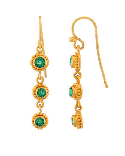 Gold earrings with green gemstones on a white background